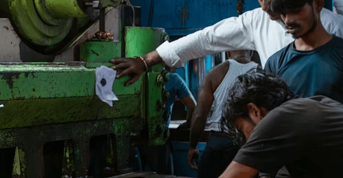 Operators loading a compression press