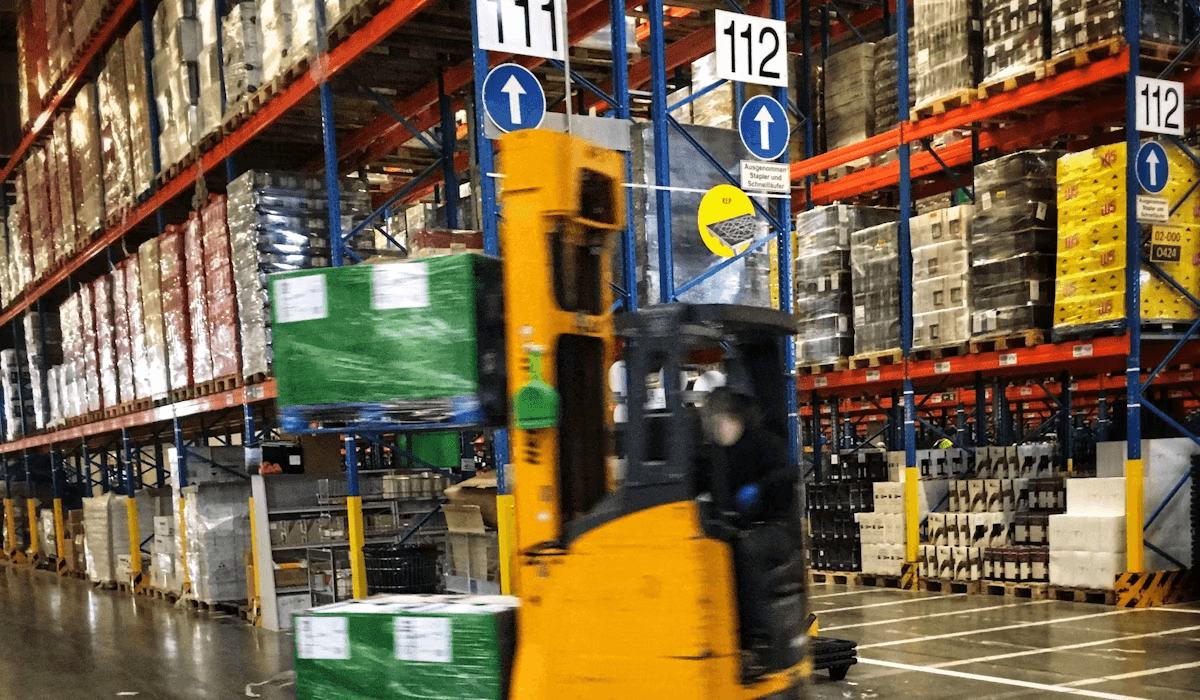 Forklift moving palletised goods in a distribution warehouse