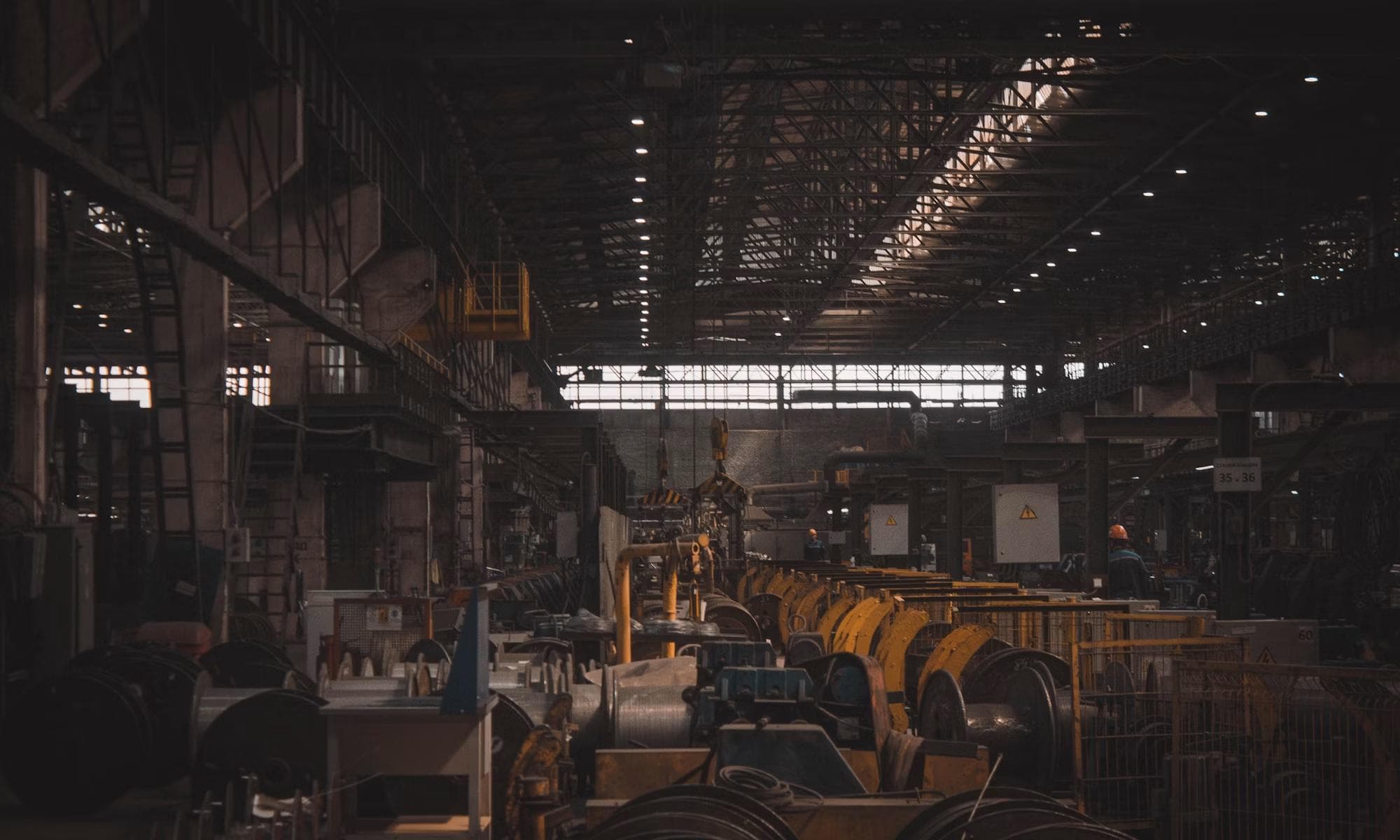 Interior of a large manufacturing hall with rows of machinery